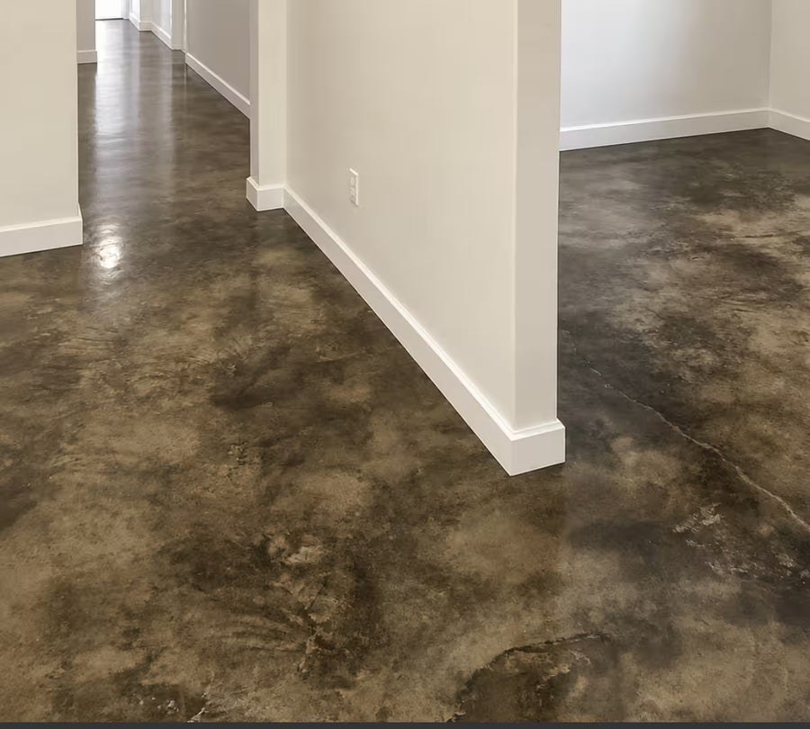 Blackish acid stain on a finished concrete floor