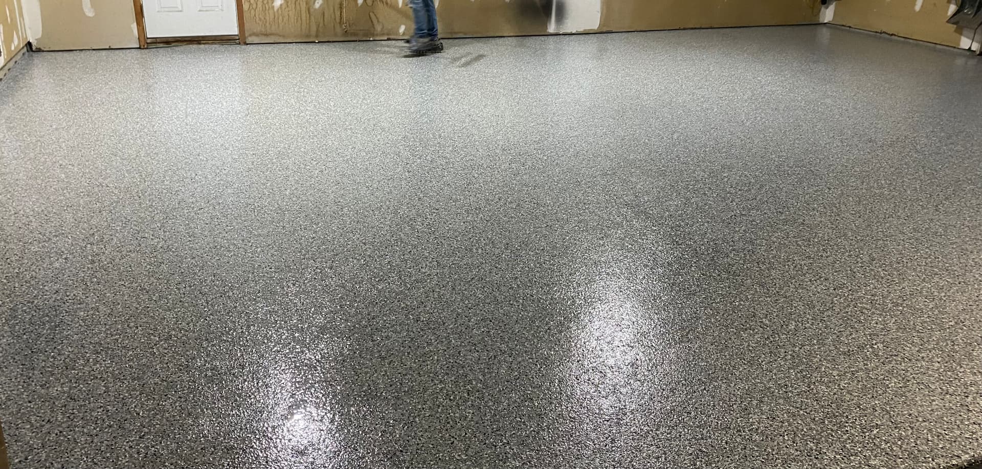 Residential Garage — Full-broadcast grey and black flake with a high-gloss clear topcoat.